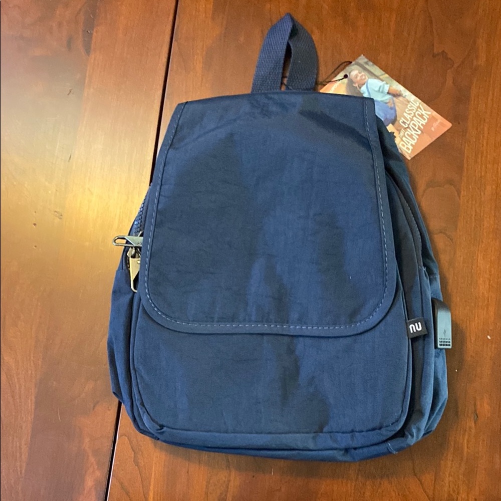 Navy Blue Backpack. Anti theft hoook.USB Port. Convertible strap